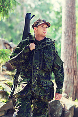 Image showing young soldier or hunter with gun in forest