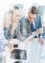 Image showing business team with tablet pc having discussion