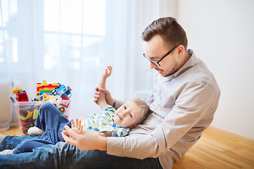 Image showing father with son playing and having fun at home