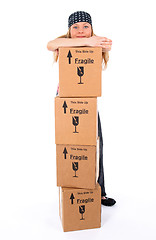 Image showing Girl with a stack of cardboard boxes