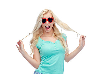 Image showing happy young woman in heart shape sunglasses