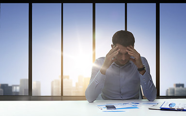 Image showing close up of anxious businessman with papers