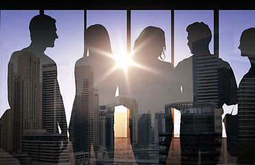 Image showing people silhouettes over city background