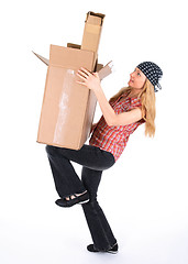 Image showing Girl balancing with cardboard boxes