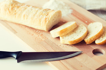 Image showing close up of white bread or baguette and knife