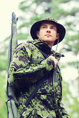 Image showing young soldier or hunter with gun in forest