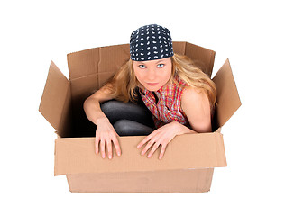 Image showing Cute girl sitting in a cardboard box
