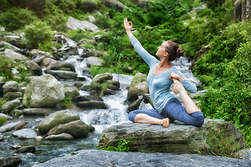 Image showing Sorty fit woman doing yoga asana outdoors