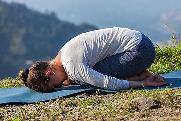 Image showing Sporty fit woman practices yoga asana Balasana