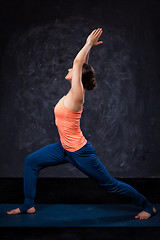 Image showing Woman practices yoga asana utthita Virabhadras
