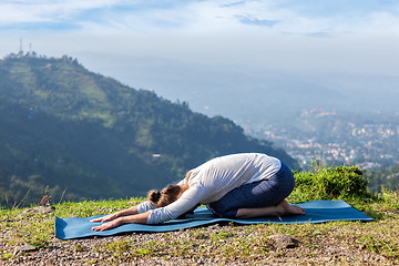 Image showing Sporty fit woman practices yoga asana Balasana