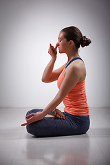 Image showing Sporty fit yogini woman practices yoga pranayama breath control 