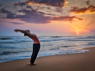 Image showing Young sporty fit woman doing yoga Surya Namaskar