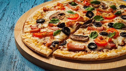 Image showing Ham pizza on blue wooden background