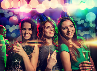 Image showing smiling friends with glasses of champagne in club