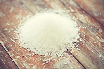 Image showing close up of white salt heap on wooden table