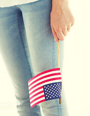 Image showing close up of woman holding american flag in hand