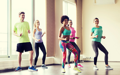 Image showing group of smiling people dancing in gym or studio