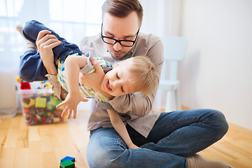 Image showing father and son playing and having fun at home