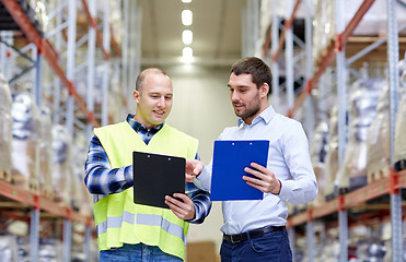 Image showing worker and businessmen with clipboard at warehouse