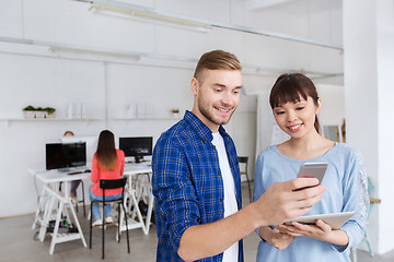 Image showing couple with smartphone and tablet pc at office