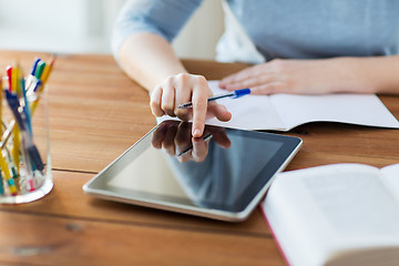 Image showing close up of student with tablet pc and notebook