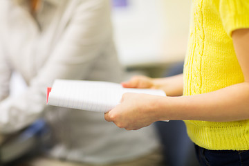 Image showing close up of girl with notebook at school lesson