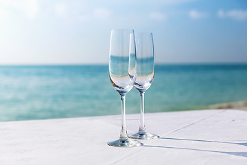 Image showing  close up of two champagne glasses on beach 