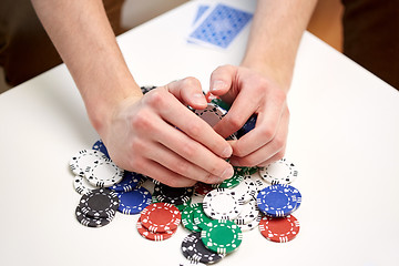 Image showing hands with casino chips making bet or taking win