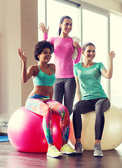 Image showing group of smiling women with exercise balls in gym