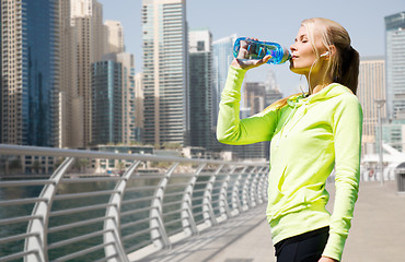 Image showing woman drinking water after doing sports outdoors