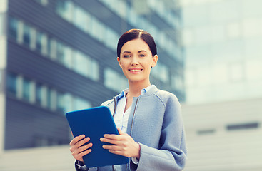 Image showing smiling business woman with tablet pc in city