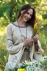 Image showing Beautiful brunette woman with field flowers