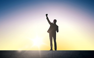 Image showing silhouette of business man with over sun light