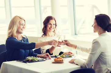 Image showing happy women drinking champagne at restaurant