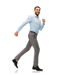 Image showing smiling young man running away