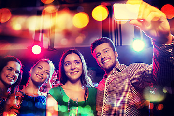 Image showing friends taking selfie by smartphone in night club