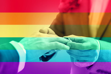 Image showing close up of male gay couple hands and wedding ring