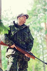 Image showing young soldier or hunter with gun in forest