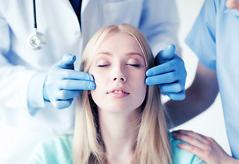 Image showing plastic surgeon and nurse with patient