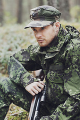 Image showing young soldier or hunter with gun in forest