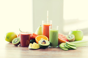 Image showing close up of fresh juice glass and fruits on table