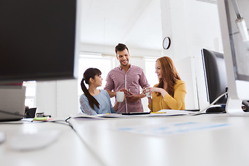 Image showing happy creative team drinking coffee at office