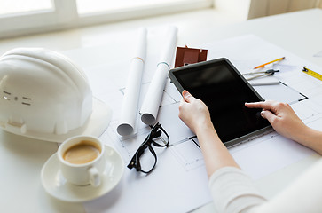 Image showing close up of hand with blueprint and tablet pc