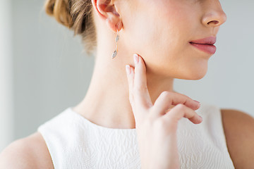 Image showing close up of beautiful woman face with gold earring