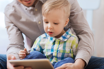 Image showing father and son with tablet pc playing at home