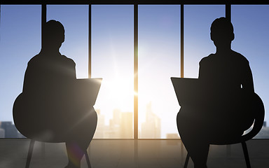 Image showing silhouette of two business women with laptop