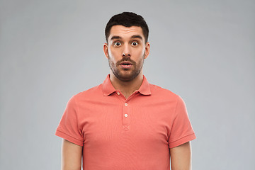 Image showing surprised man in polo t-shirt over gray background