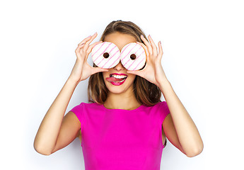 Image showing happy woman or teen girl looking through donuts