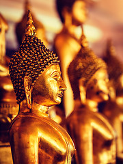 Image showing Golden Buddha statues in buddhist temple